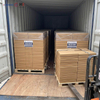 Pallets of wholesale food grade wrapping paper being loaded into a shipping container at the Heming Paper factory