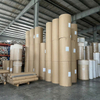 Massive inventory of wholesale sublimation paper jumbo rolls standing vertically in our climate-controlled factory warehouse