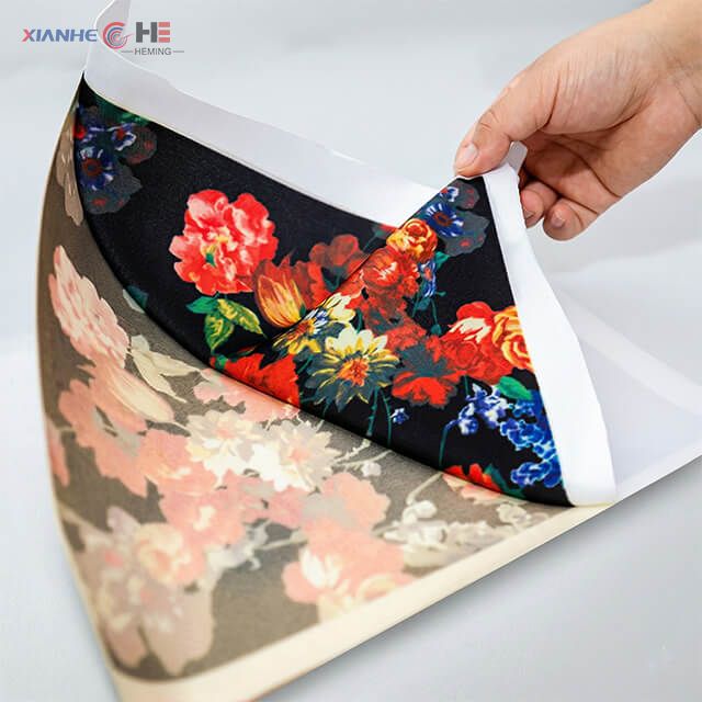 Dye sublimation roll feeding into high-speed industrial printer