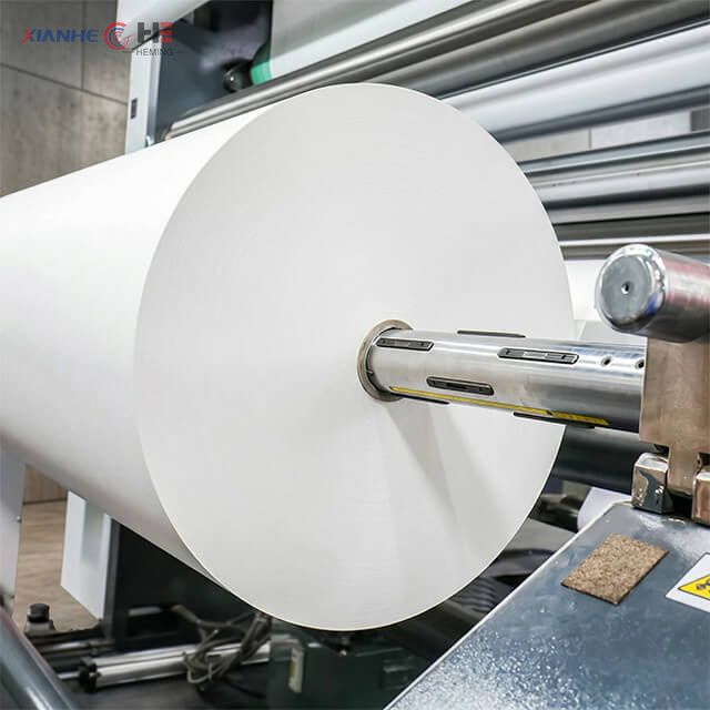 Dye sublimation roll feeding into high-speed industrial printer