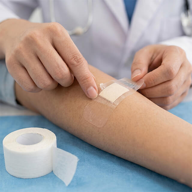 Medical tape and wound dressing using biocompatible glassine base paper liner.