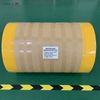 Industrial sized grease paper roll securely wrapped in yellow protective moisture-proof film