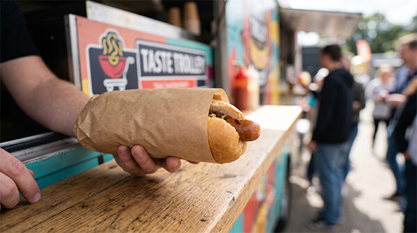 Brown kraft greaseproof wrapping paper for hot dogs and sandwiches at a food truck
