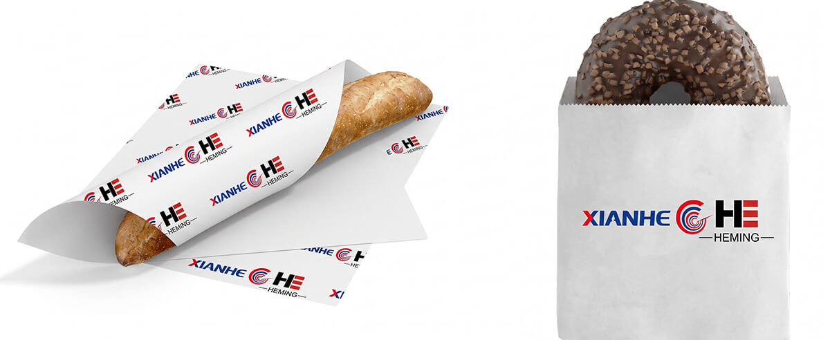 Hand holding a juicy burger wrapped in commercial greaseproof paper to prevent oil leaks.