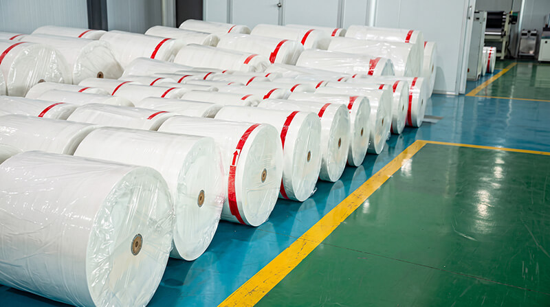 Industrial silicone baking paper jumbo rolls in factory workshop ready for overseas converting