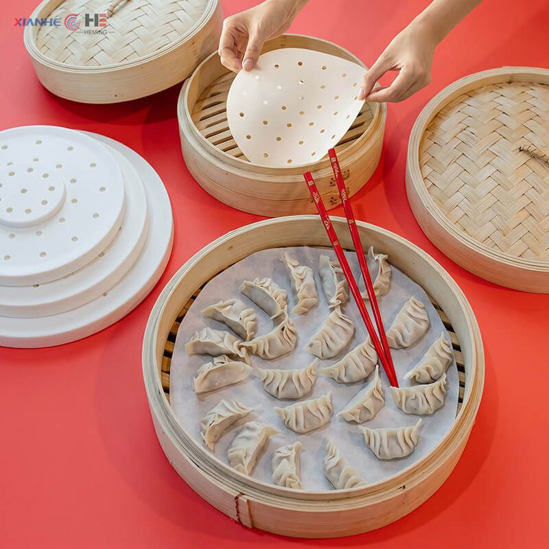 Round parchment steamer paper liner placed in bamboo steamer filled with Chinese dumplings