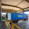 Forklift loading export container with palletized paper products at Heming Paper factory bay