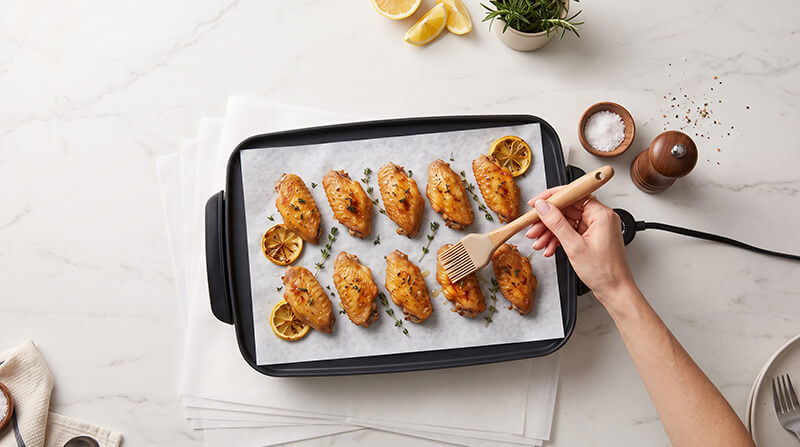 Commercial precut silicone baking paper sheets lining a baking pan for non-stick oven cooking