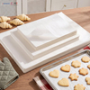Stacks of flat precut baking paper sheets for half and full size sheet pans