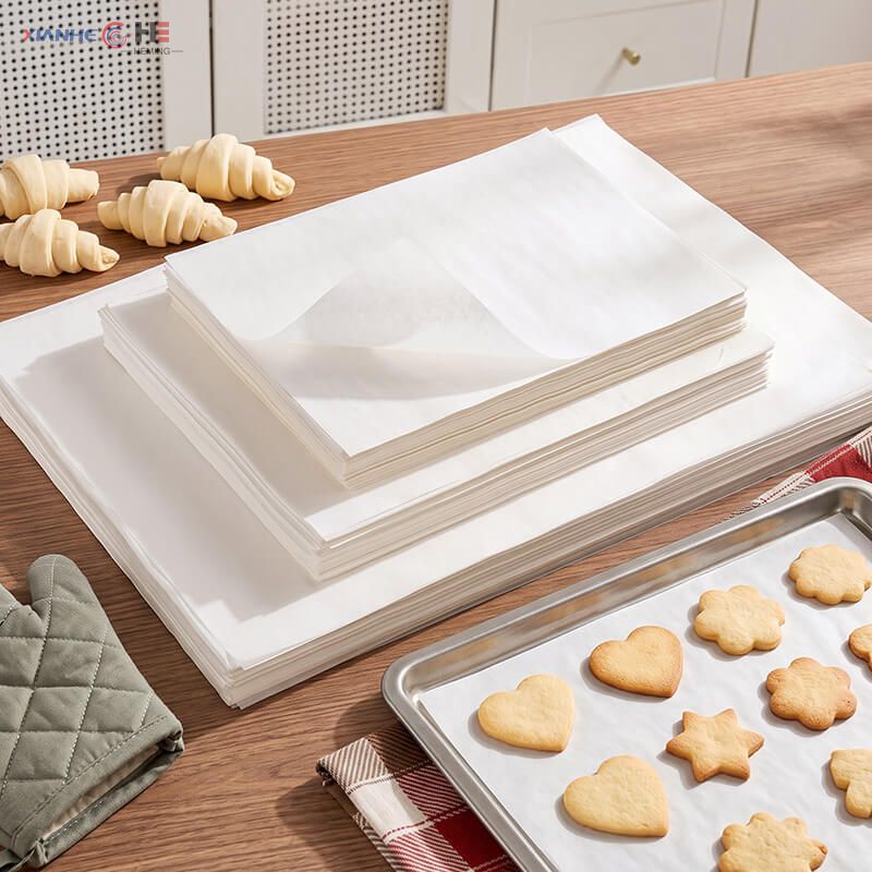 Stacks of flat precut baking paper sheets for half and full size sheet pans