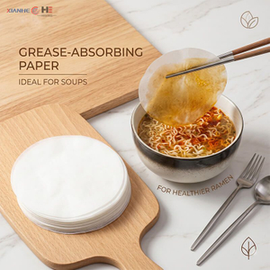 Stack of 16gsm oil absorbing paper for food next to a hot meal