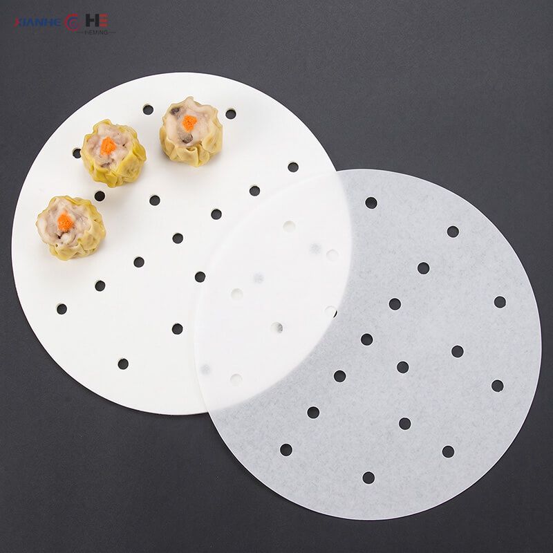 Double-sided silicone coated perforated steamer paper rounds with steamed dim sum siu mai