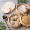 Round steamer paper liner preventing steamed Cantonese har gow shrimp dumplings from sticking