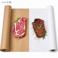 White and brown butcher paper rolls displayed with fresh ribeye and grilled steak