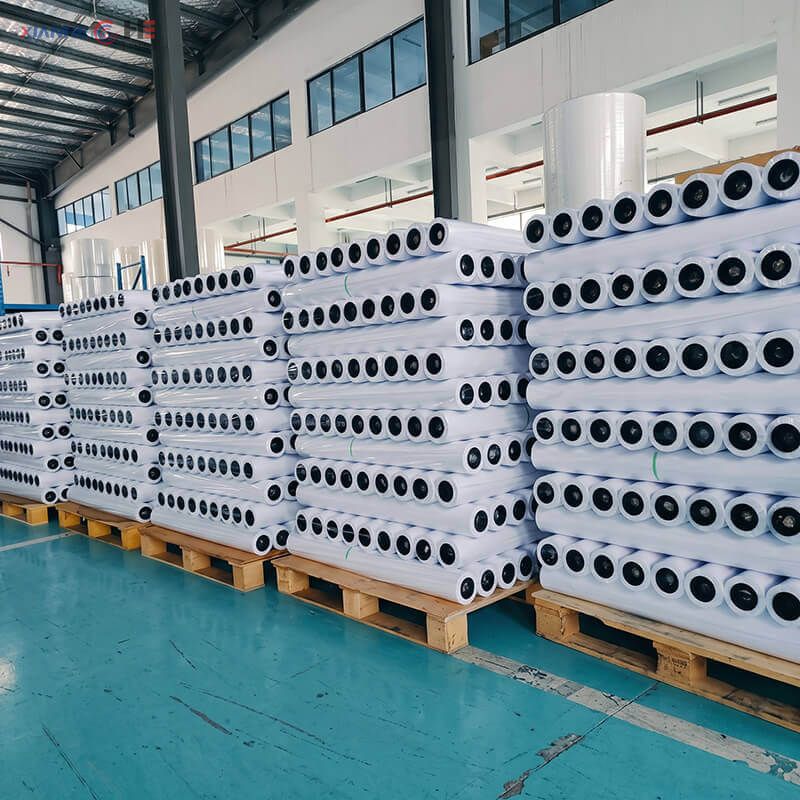 Pallets of wholesale silicone baking paper rolls packed on wooden pallets in factory warehouse