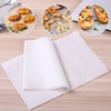 Ream of white greaseproof paper sheets with icons showing baking and grilling applications