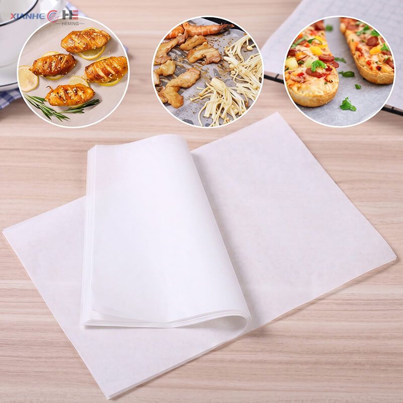 Ream of white greaseproof paper sheets with icons showing baking and grilling applications