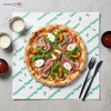 Square greaseproof paper sheets placed under hot pizza as oil-resistant box and tray liners