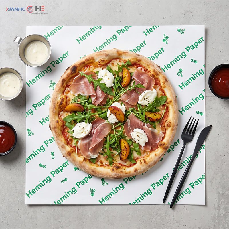 Square greaseproof paper sheets placed under hot pizza as oil-resistant box and tray liners