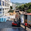Forklift loading glassine paper rolls into 40HQ shipping container
