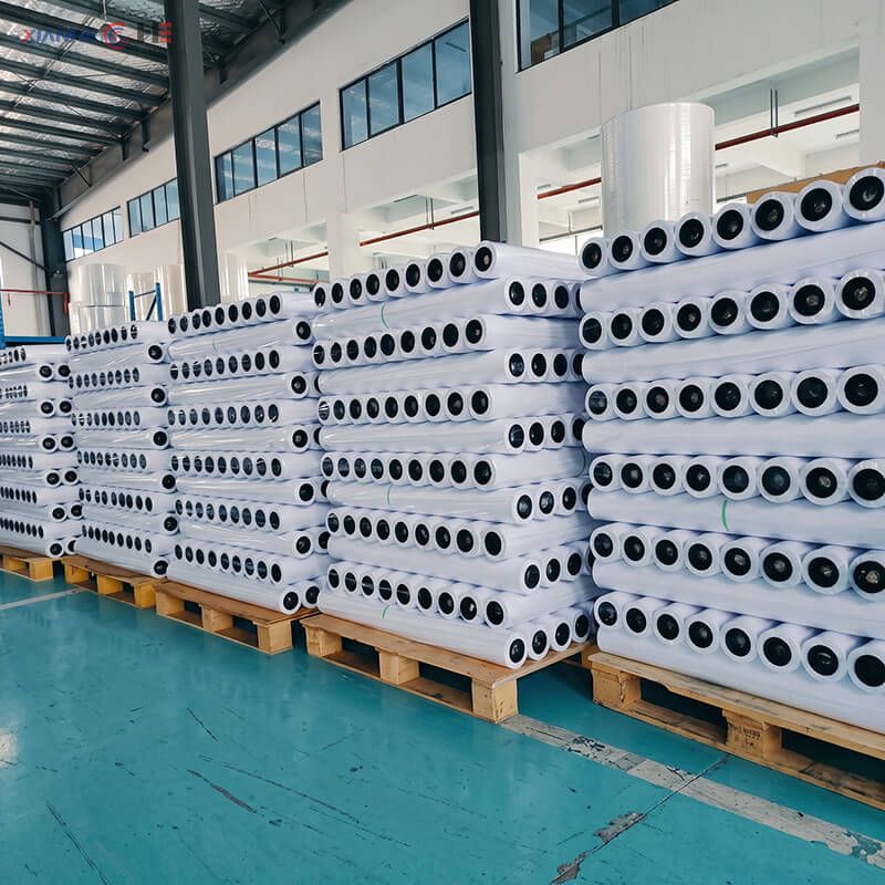 Palletized greaseproof paper slit rolls wrapped in PE stretch film for container export shipping