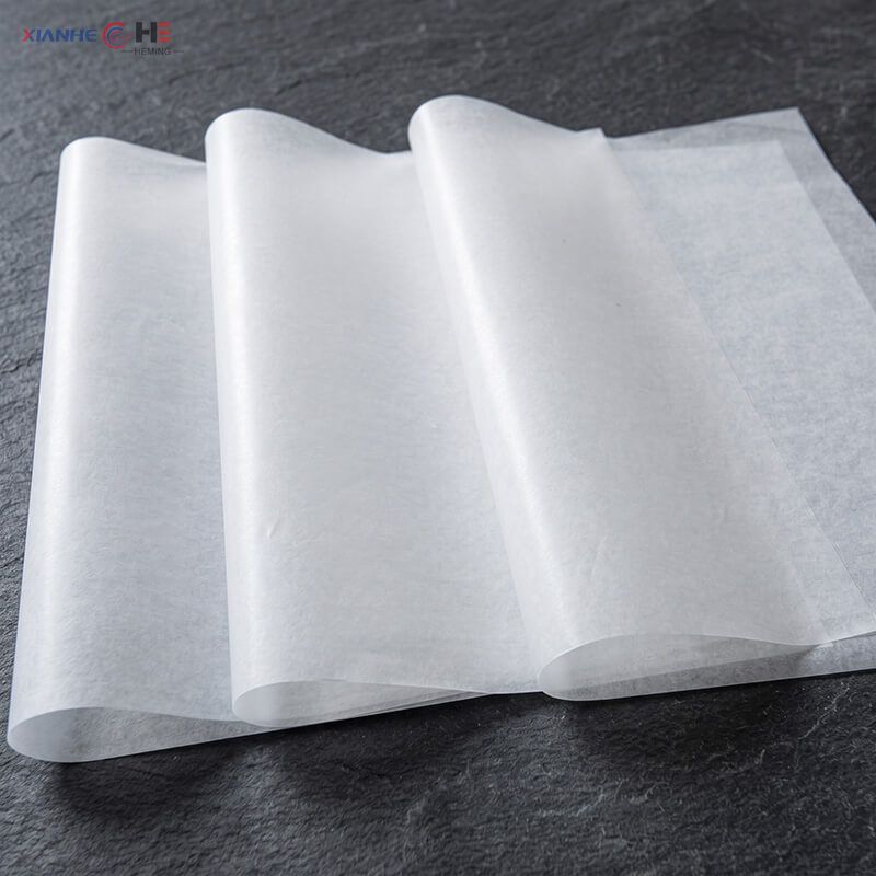 Stacked virgin pulp greaseproof paper sheets demonstrating supercalendered smooth surface